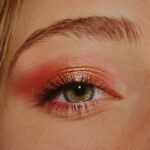 woman with pink and gold eyeshadow makeup