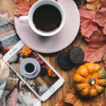 a cup of coffee and a cell phone on a table