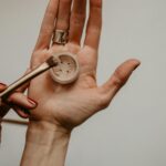 person holding silver round analog watch