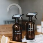 two brown spray bottles on brown table